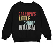 a black sweatshirt with the words grandpa's little champ william on it