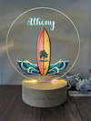 a light up surfboard with a palm tree on it