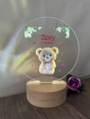 a personalized glass plaque with a teddy bear on it