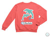 a pink sweatshirt with two dolphins on it