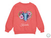 a pink sweatshirt with a heart and flowers on it