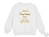 a white sweatshirt with gold foil lettering on it