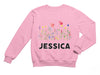 a pink sweatshirt with the name of a flower garden